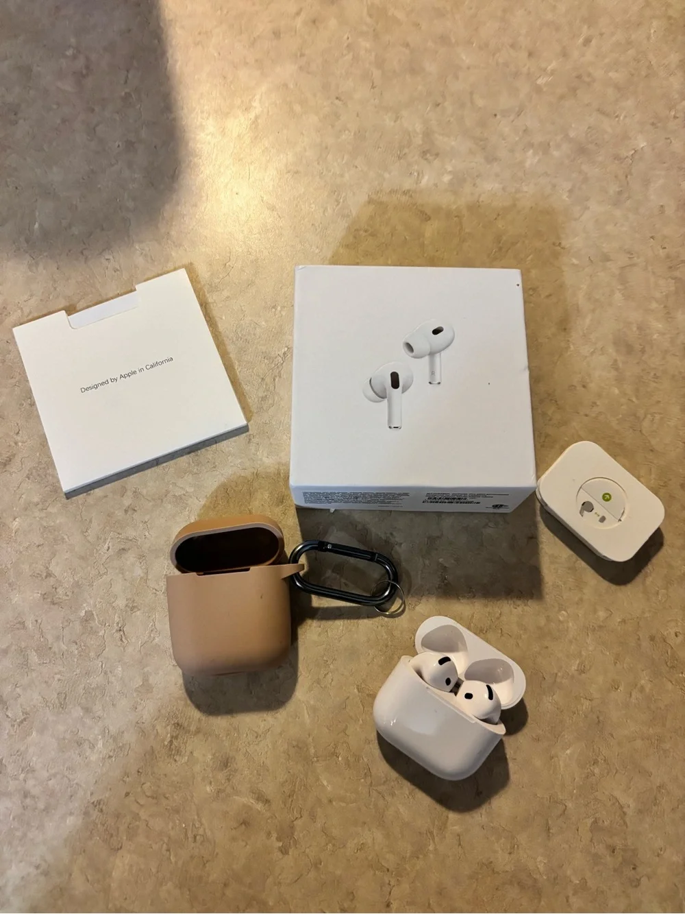 Apple AirPods Pro with White Earbuds and Tan Silicone Case